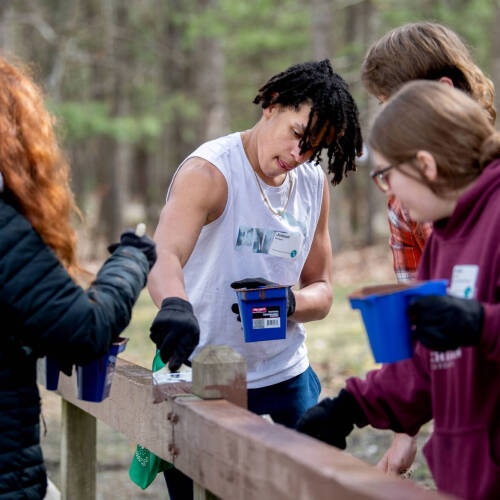 Jedaiah Armour, center, and fellow students from Byron Center Charter School volunteered with Michigan Cares 4 Tourism at the Muskegon Luge Adventure Sports Park and Muskegon State Park on April 19.